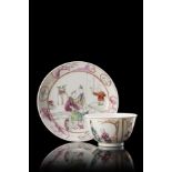 A Famille Rose cup and saucer, decorated with figures in interiors China, 18th century (diam.