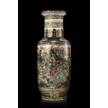 A large rouleau Famille Verte vase decorated with armed warriors on horses engaged in battles (