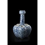 A blue and white tulip vase, composed by five conjoined sections and a tall neck with a bud mouth,