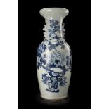 A celadon-ground blue and white baluster vase, decorated in relief with birds and flowers (flaws and