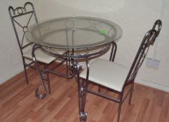 1 x Round Glass Topped Table With 2 Chairs. Beaten Metal Frame.