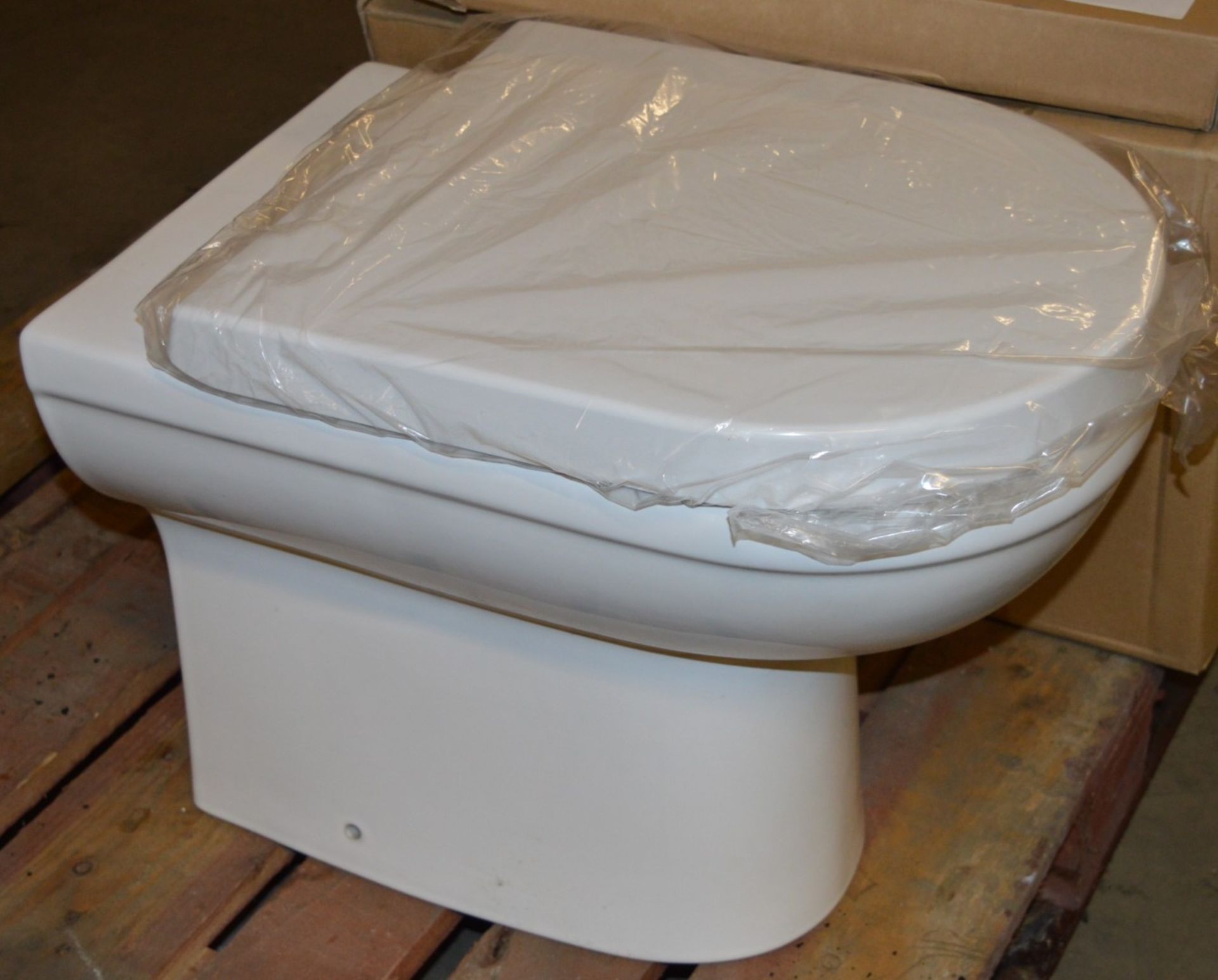 1 x Back to Wall Toilet Pan With Seat - Unused Stock - CL190 - Ref BR080 - Location: Bolton BL1