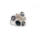 Anello in oro bianco 18Kt con diamante a pavè ct. 0,35 e tre fiori con petali in zaffiri blu