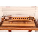 Circa 20th c Scale of a Model Boat designed with round seats, canvas top and mounted with oars and