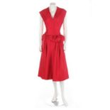 A red silk couture dress, circa 1955, with padded, twisted band to the low waistline,