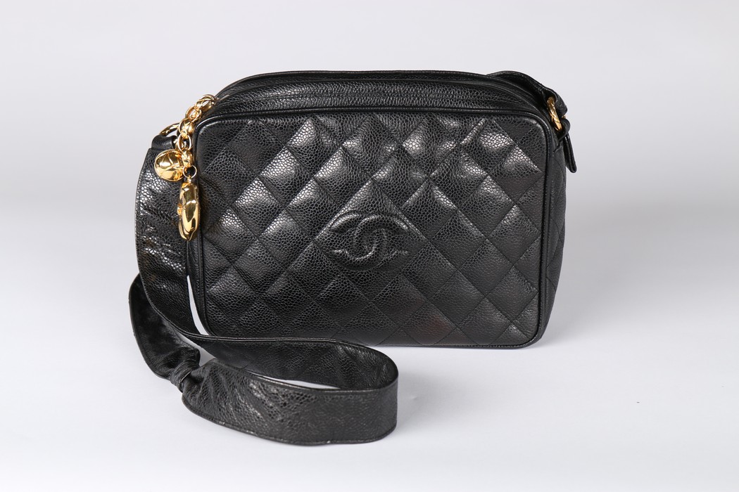 A Chanel caviar leather quilted shoulder bag, 1980s, stamped to interior, with two gilt pendants,