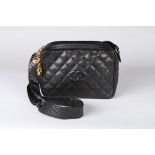 A Chanel caviar leather quilted shoulder bag, 1980s, stamped to interior, with two gilt pendants,
