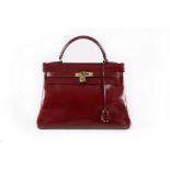 An Hermès ox-blood leather Kelly bag, 1960s, stamped 'Bonwit Teller Hermès-Paris',