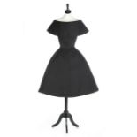 A Christian Dior couture black satin cocktail dress 'Promise' model, 'Fuseau' (Spindle) line,