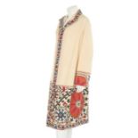 An ivory silk summer coat made from a Central Asian embroidered suzani, circa 1928,