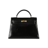 An Hermès black leather Kelly bag, 1960s, stamped 'Hermès Paris', with gilt hardware, 33cm,