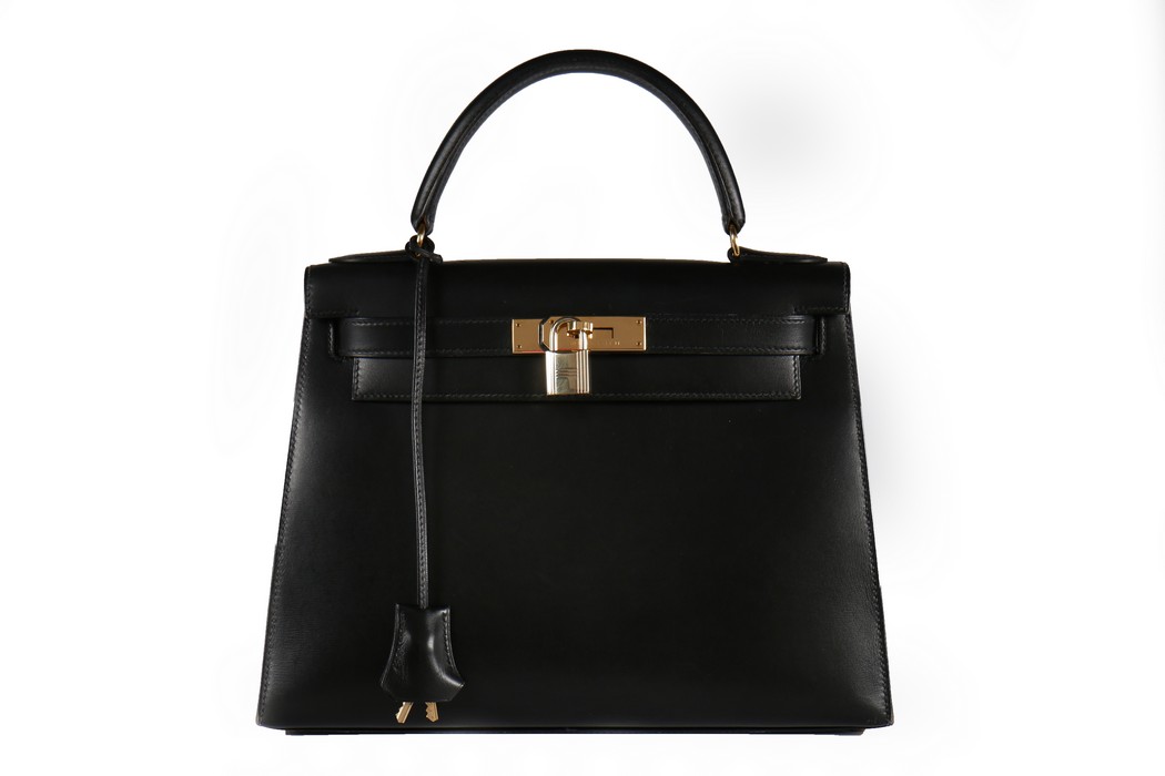 An Hermès black leather Kelly bag, 1993, blind stamp W, with gold-plated metal hardware,