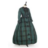 A peacock-blue and black tartan silk dress, circa 1865, adorned with black rosettes, bust 92cm,