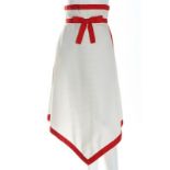 A Pierre Cardin white pique skirt, 1970, Paris, New York label, with broad red woven tape bow,