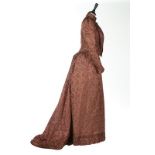 A satin damask gown, 1890s, un-labelled, woven with repeats of leaves, with day and evening bodices,