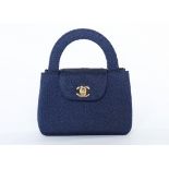 A Chanel navy soutache evening bag, 1990s, stamped to interior, short, curved handles and CC clasp,