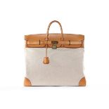 An Hermès Haut à Courroies overnight bag, 1990, blind stamp T, of canvas and tan leather,