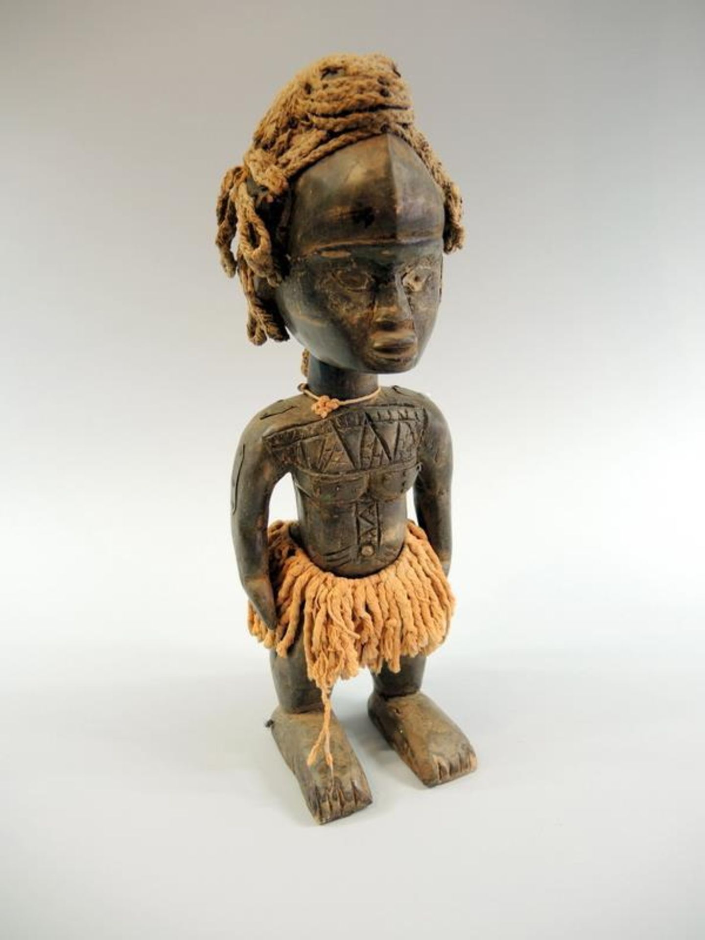 Figur mit Kaurimuschelkette Holz geschnitzt, Metallbeschläge, Naturfasern und Kaurimuschelkette.