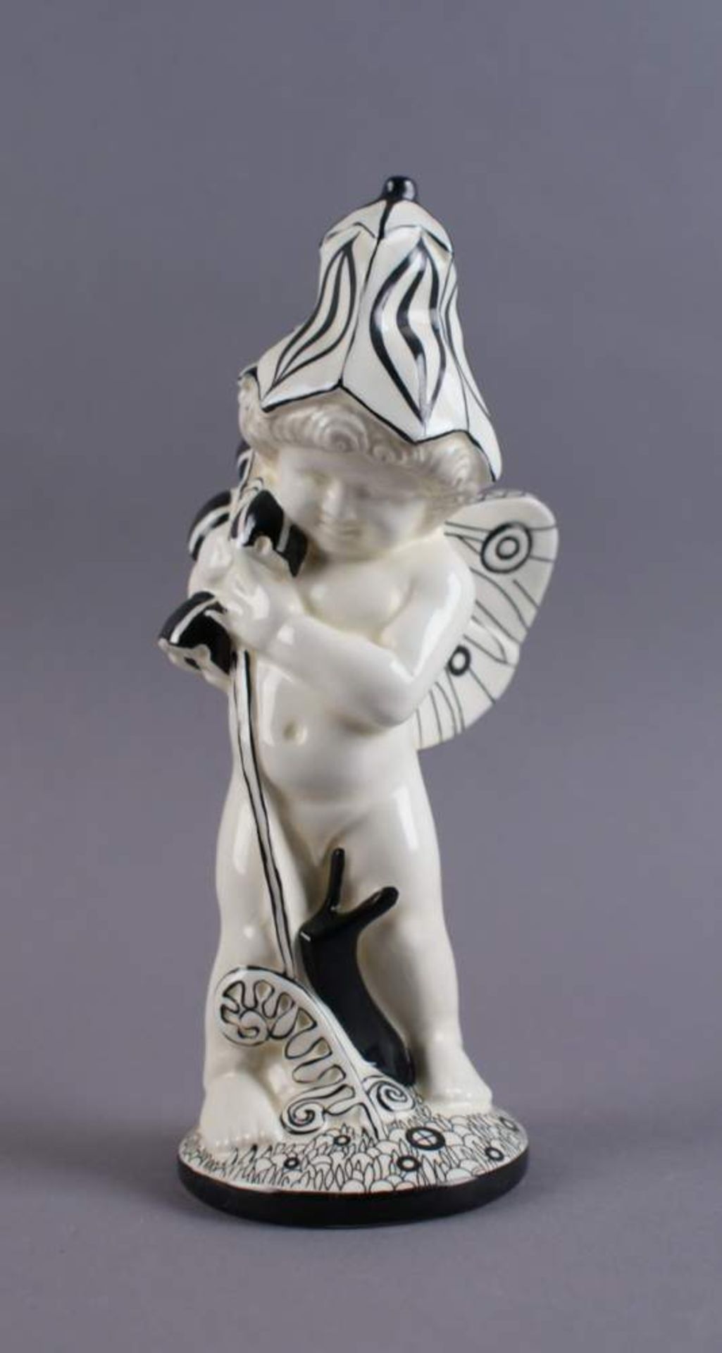 PUTTO MIT BLUMEN nach Michael Powolny, Skulptur eines Puttos mit Blumen im Arm, gem., H 19cm