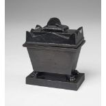 A black patinated cast iron writing set formed as Napoleon's grave Concealing a pounce box and ink