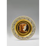 A plate with cameo painting made for Princess Louise The border decorated with gilt palmettes, the