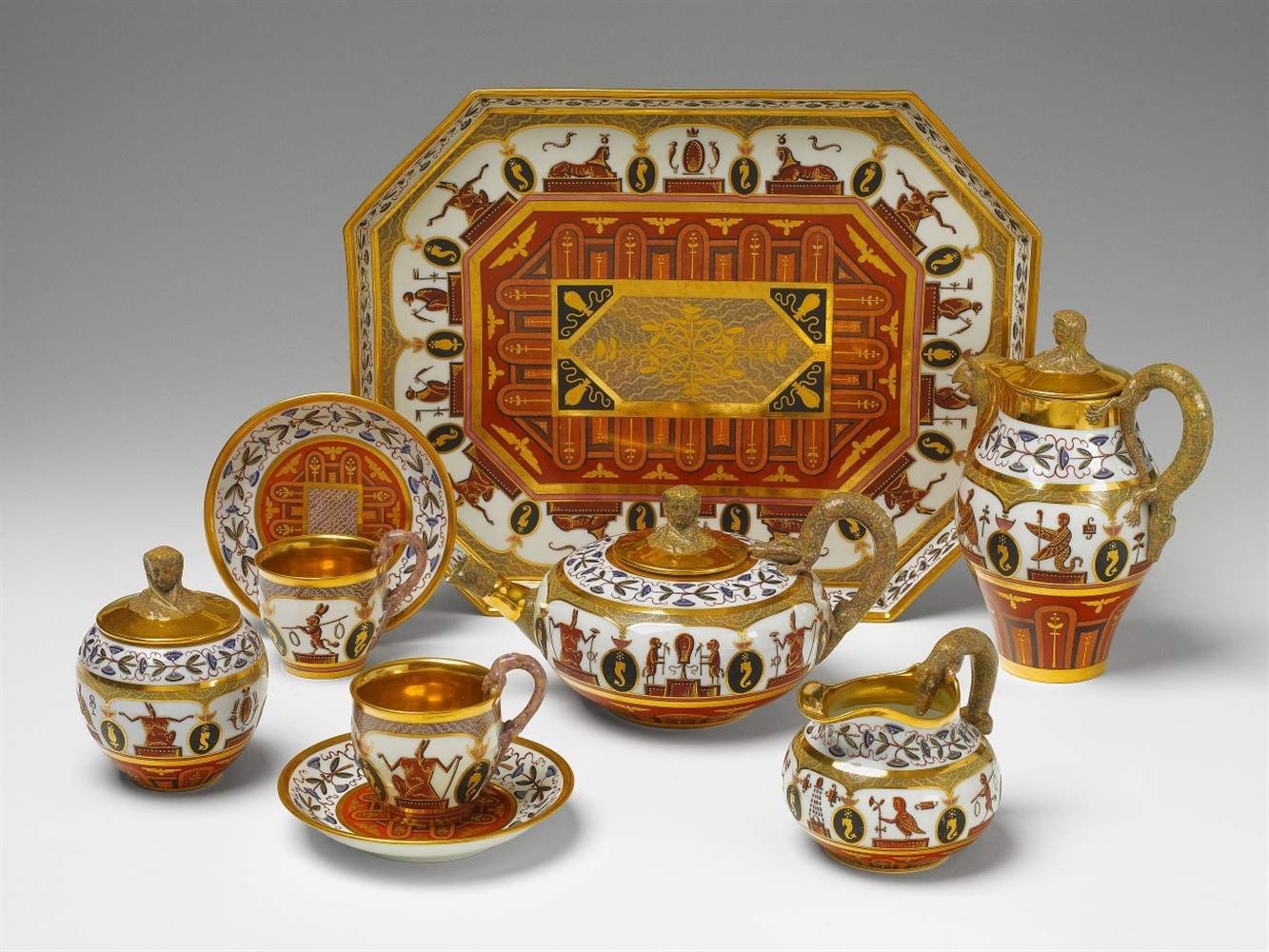 A rare Berlin KPM porcelain tête-à-tête decorated in the Egyptian taste Comprising tray, teapot