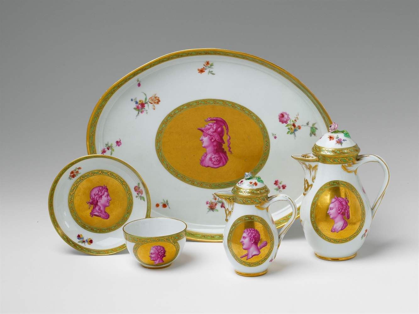 Pieces from a Berlin KPM porcelain tea set Comprising a tray, two pots and a teacup and saucer.