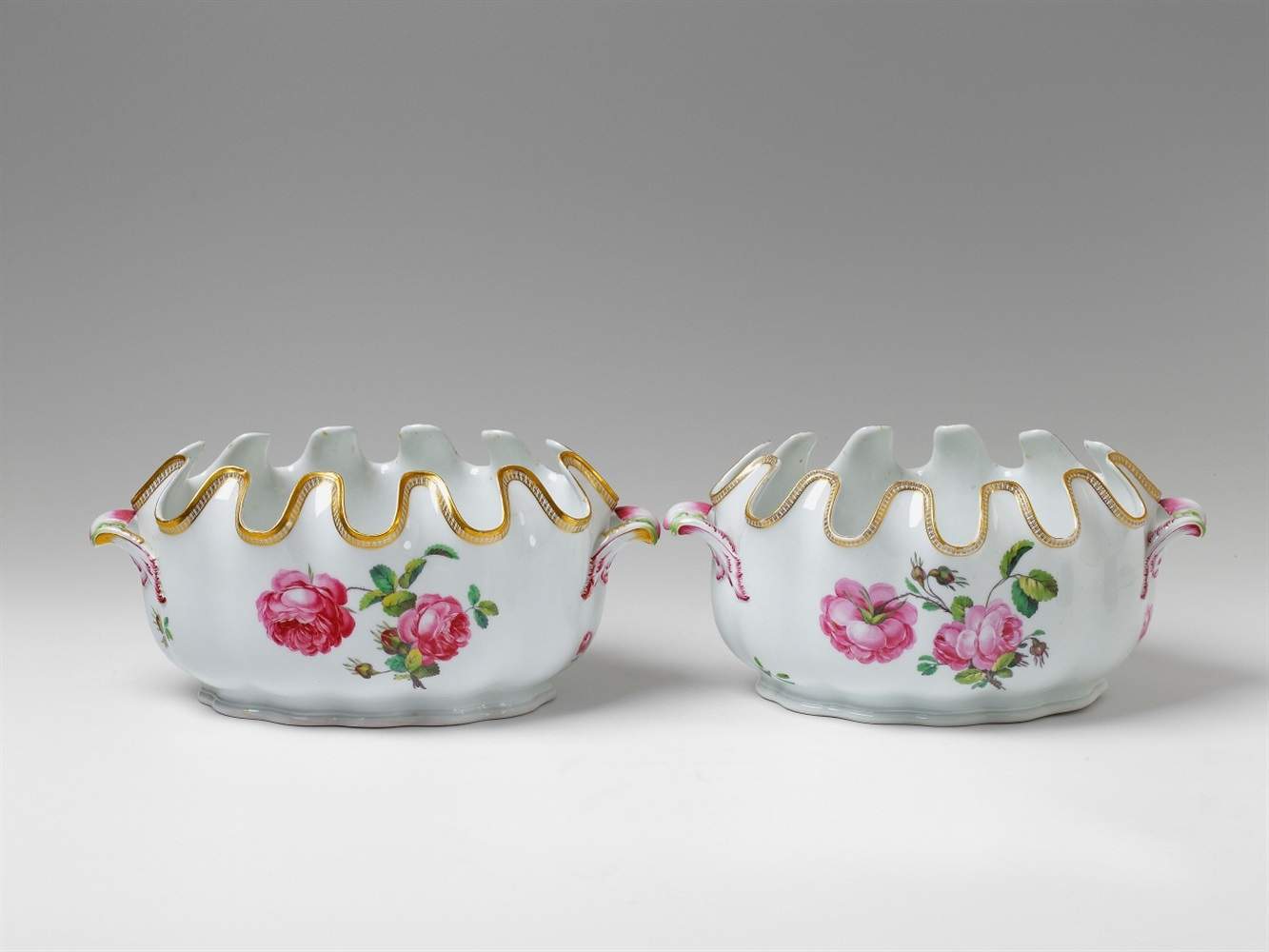 Two Berlin KPM porcelain wine coolers Of oval, scalopped form, decorated with scattered flowers