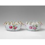 Two Berlin KPM porcelain wine coolers Of oval, scalopped form, decorated with scattered flowers