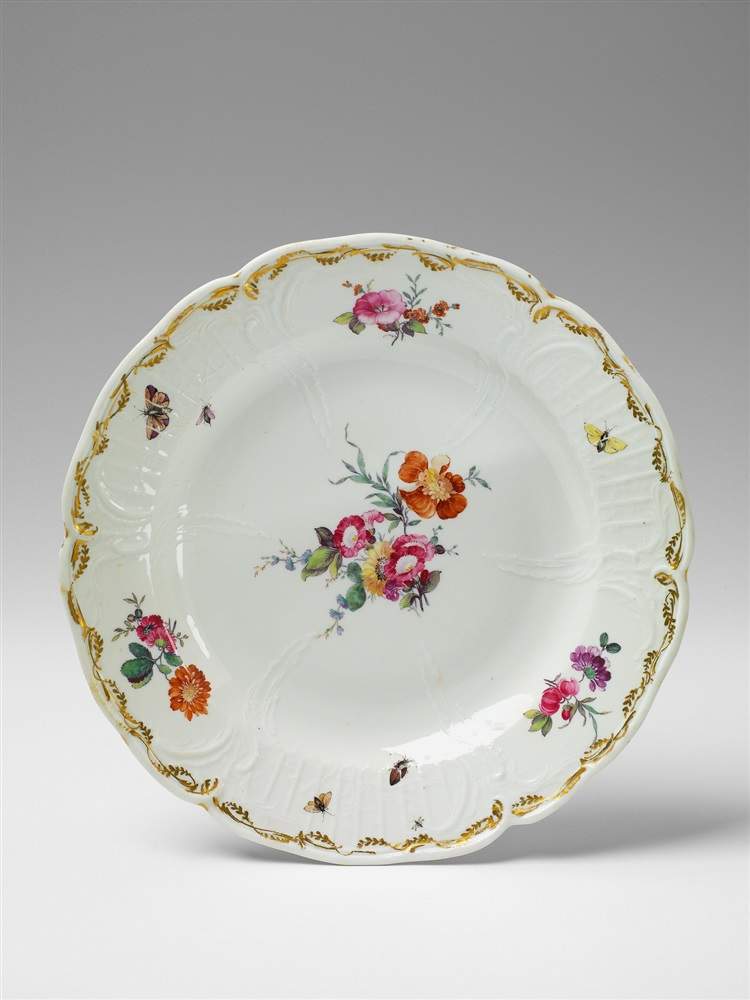 A Berlin KPM porcelain plate made for Berlin Palace. With bold floral and insect decor. Blue sceptre