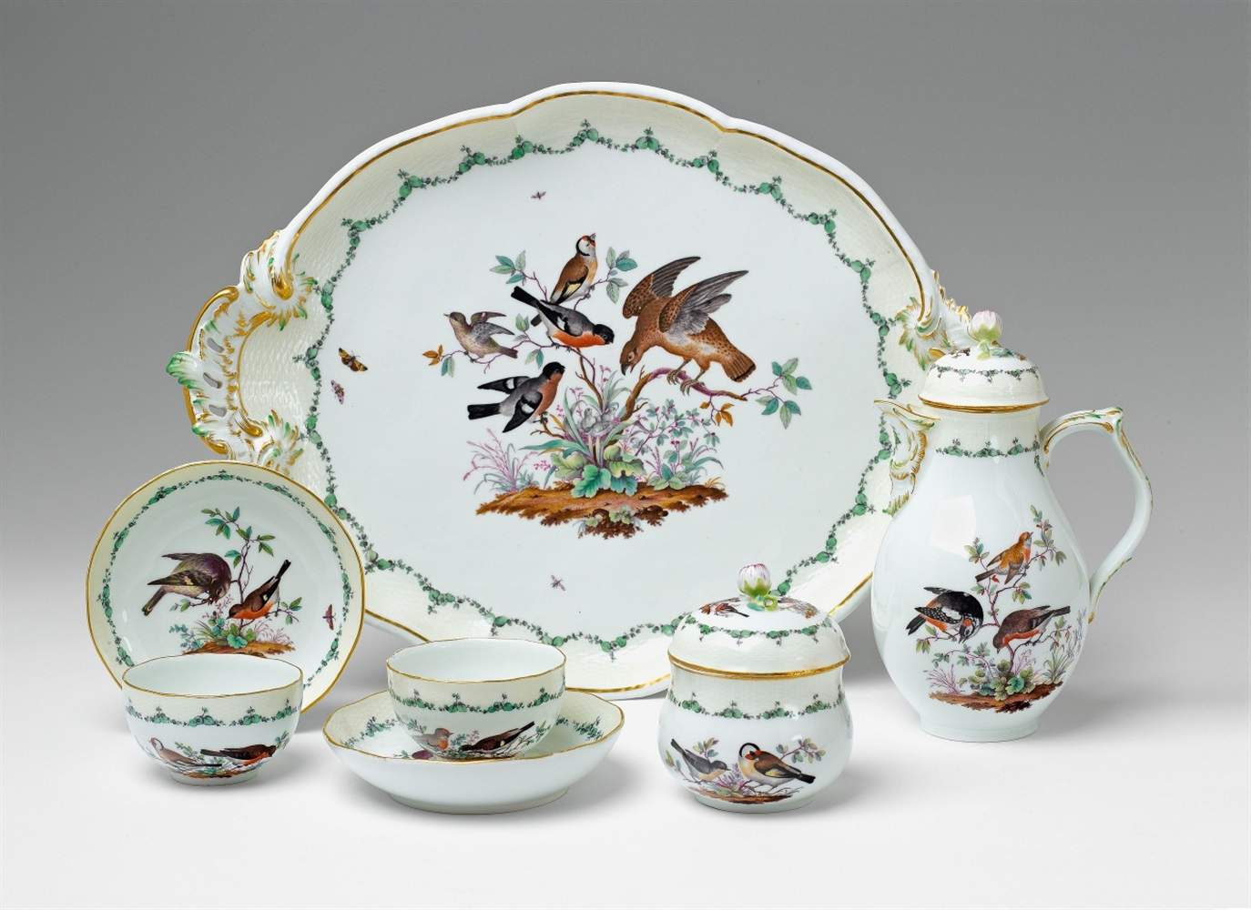 Pieces from a Berlin KPM porcelain tea service with native birds Comprising tray, coffee pot,