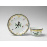 A Berlin KPM porcelain cup and saucer with bird and insect decor Blue sceptre mark, impressed 10.