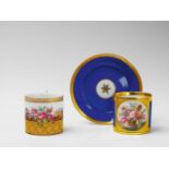 Two Berlin KPM Neoclassical cups and saucers One with finely painted floral still lifes on blue