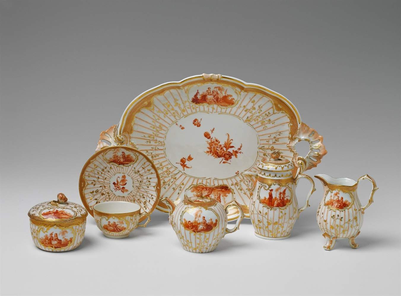 A Berlin KPM porcelain solitaire with scenes after Watteau Comprising a tray, milk jug, teapot,