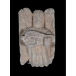 Sculpted stone figure depicting an angelic musician. Circa 1400. 27 x 17 x 15 cm.