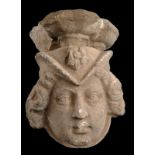 Limestone wall mount sculpted on one side and depicting a woman’s head with a headdress decorated