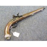 A decorative Eastern type flintlock pistol. Action a/f. Silver coloured decoration. Barrel painted