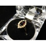 9ct Gold Ring with a Marquise Garnet surrounded by seed Pearls size O weight 2.8 grams