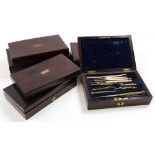 Six drawing / compass sets, each in rosewood box, containing numerous compasses