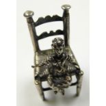 Silver miniature of a child on a chair - 2. Marks are not readable, the other Dutch Export key