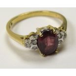 18ct Gold Ring with central Garnet and Diamond set shoulders