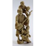 Japanese ivory Okimono of a musician playing a shamisen with a child at his feet and one on his