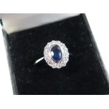 18ct White Gold Ring set with central Sapphire surrounded by Diamonds size L weight 4.6 grams