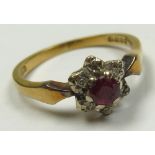 18ct Gold Ring with Ruby and Diamonds in a Floral setting size K weight 2.8 grams