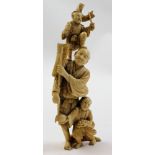 Japanese ivory Okimono of a man with a child at his feet and one on his shoulder, signed on base