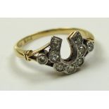 18ct Gold ring with horseshoe setting of 9 Diamonds size N weight 2.7 grams