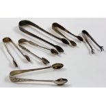 Six pairs of sugar tongs - including a Georgian pair dated London 1802. Weight - approx. 4oz.