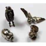 Three unmarked silver pendants (parrot, pigeon and pig) and one silver poodle marked 800. Weight