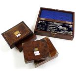 Five drawing sets, each in walnut box, containing numerous compass
