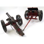 Cast iron cannon with wooden frame and carriage, total length approximately 36 inches